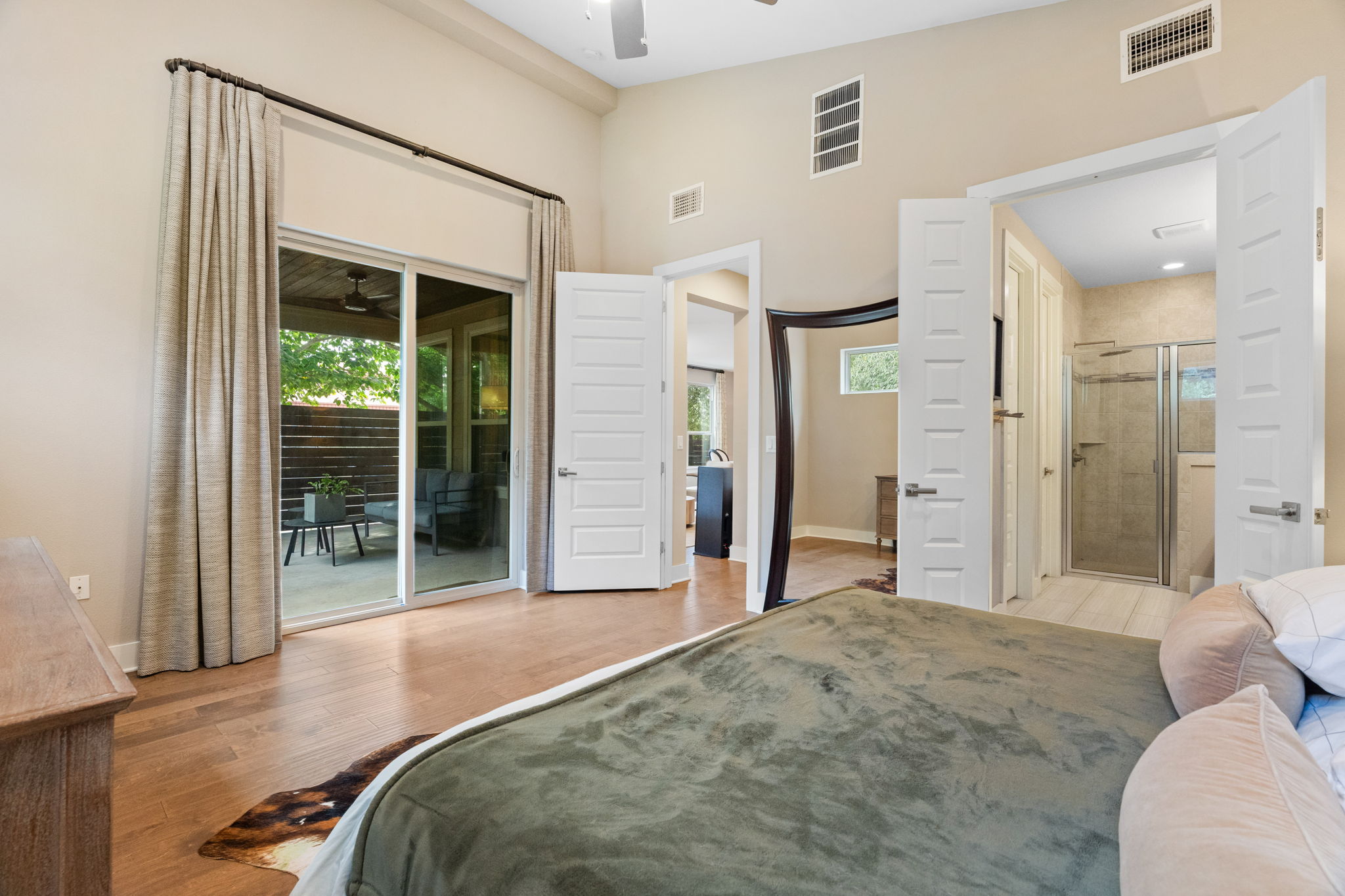 3707 Birch Street, Unit B Austin, TX 78704 - Photo 25 of 40 The primary has it's own en suite bathroom and opens onto the back patio, perfect for coffee in the morning.