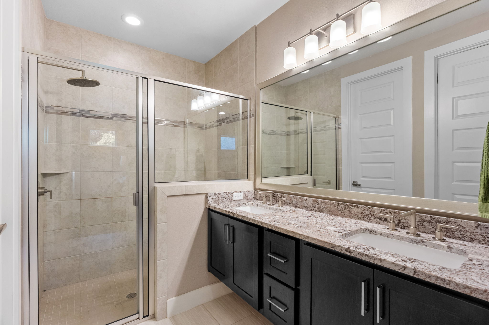 3707 Birch Street, Unit B Austin, TX 78704 - Photo 26 of 40 The ensuite bathroom features a dual vanity, light tile patterned floors, and recessed lighting.