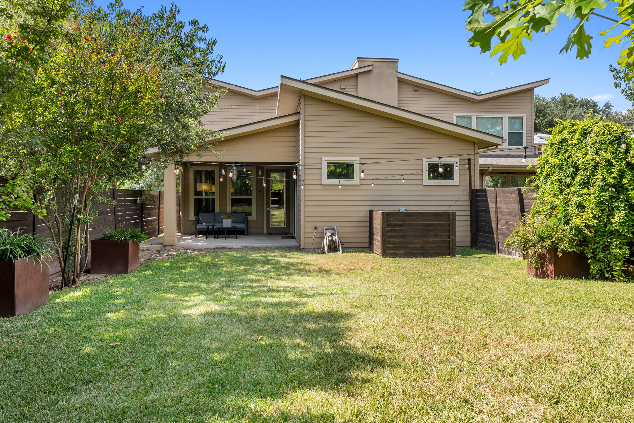 3707 Birch Street, Unit B Austin, TX 78704 - Photo 36 of 40 Dine al fresco and enjoy the gorgeous planter boxes, the beautiful red oak tree and blooming crepe myrtles and vines as they change with the seasons.