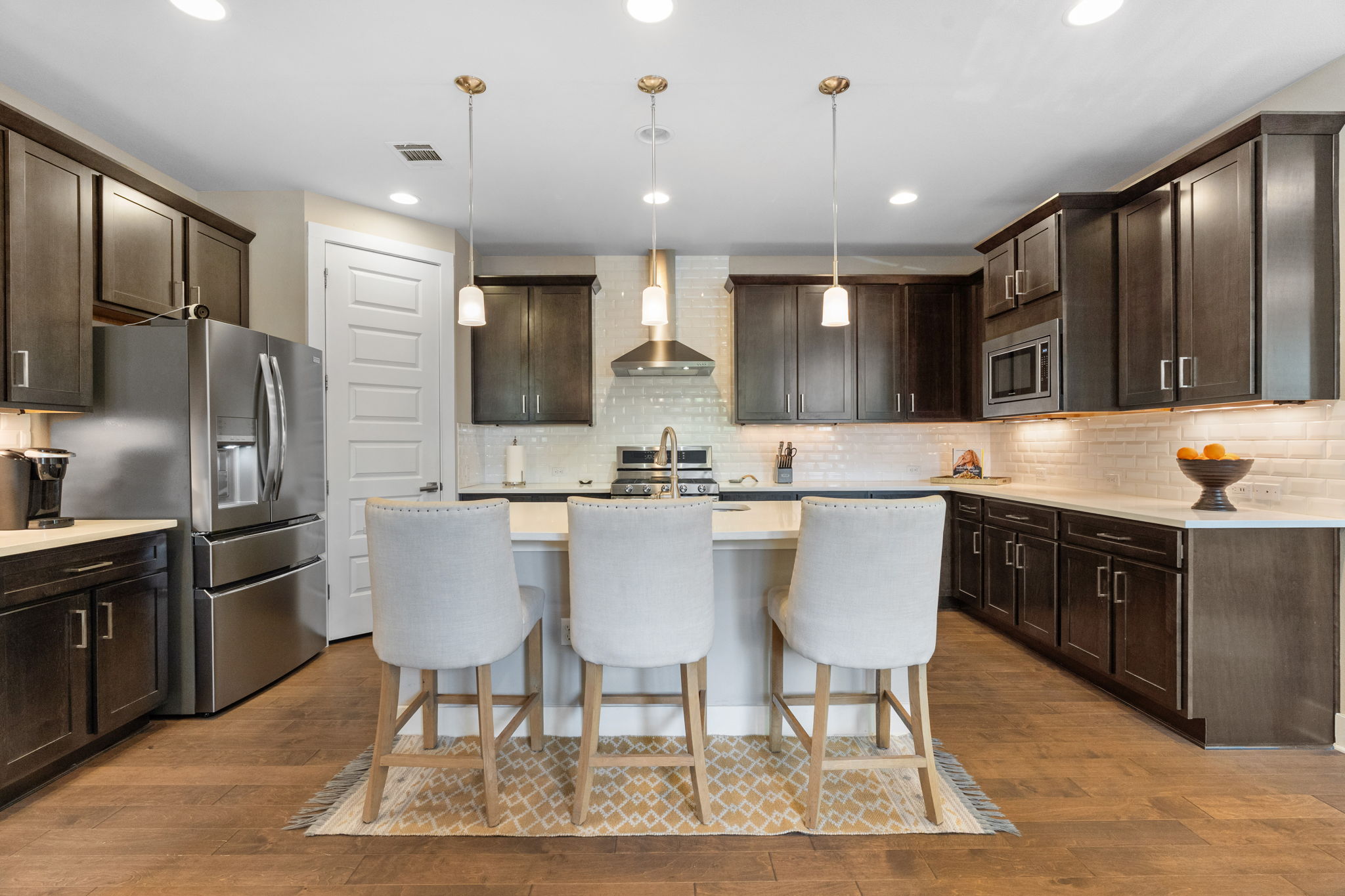 3707 Birch Street, Unit B Austin, TX 78704 - Photo 4 of 40 Beautiful open kitchen complete with island, quartz countertops and subway tile backsplash.