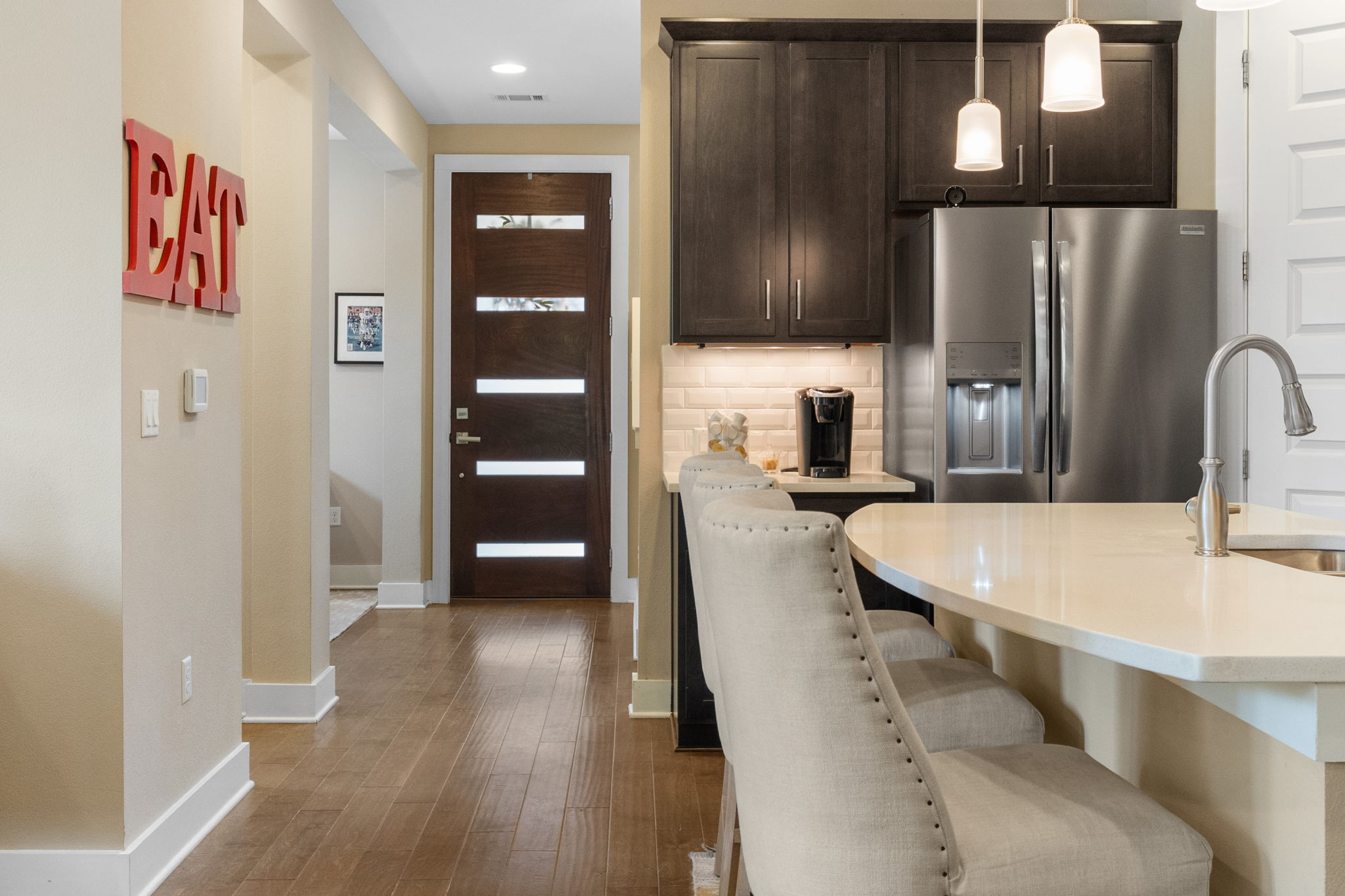 3707 Birch Street, Unit B Austin, TX 78704 - Photo 39 of 40 As you step through the front door, the open floor plan draws you in with its airy ambiance, highlighted by lofted ceilings, recessed lighting and gorgeous hardwood floors.