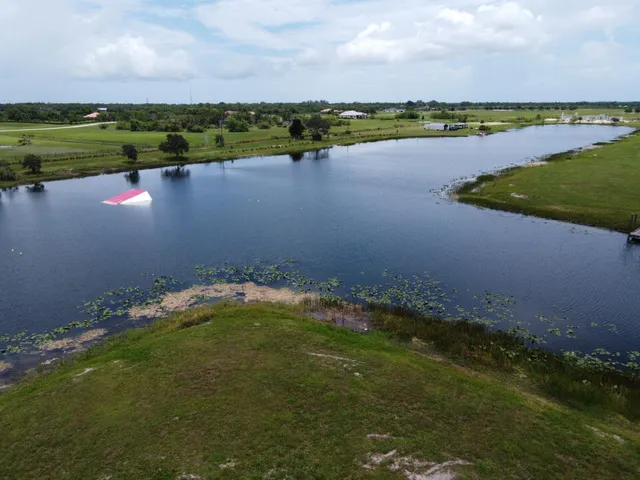 a view of a lake with houses in the background
