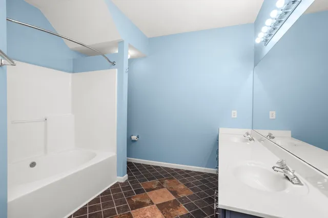 a bathroom with a bathtub and a shower