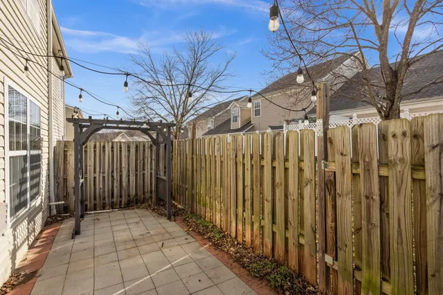 a view of a house with a wooden fence