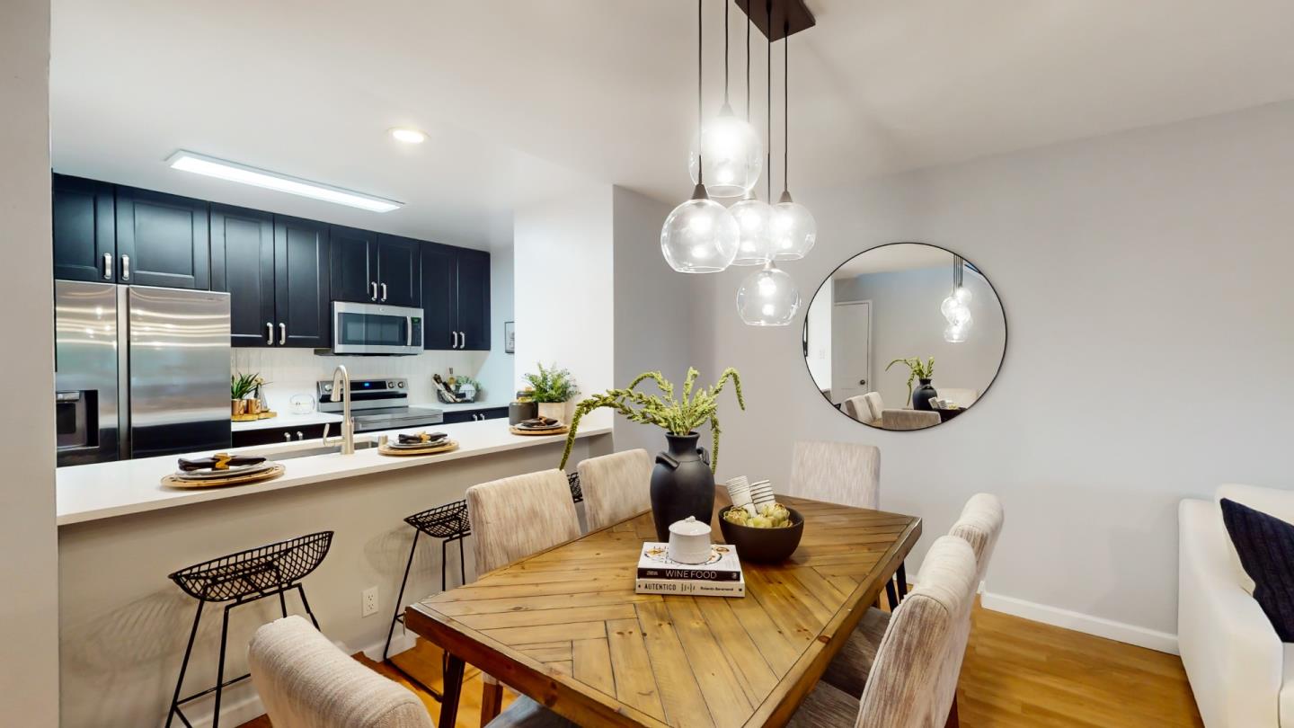2201 The Alameda, Unit 27 Santa Clara, CA 95050 - Photo 8 of 25 a kitchen with a dining table and chairs
