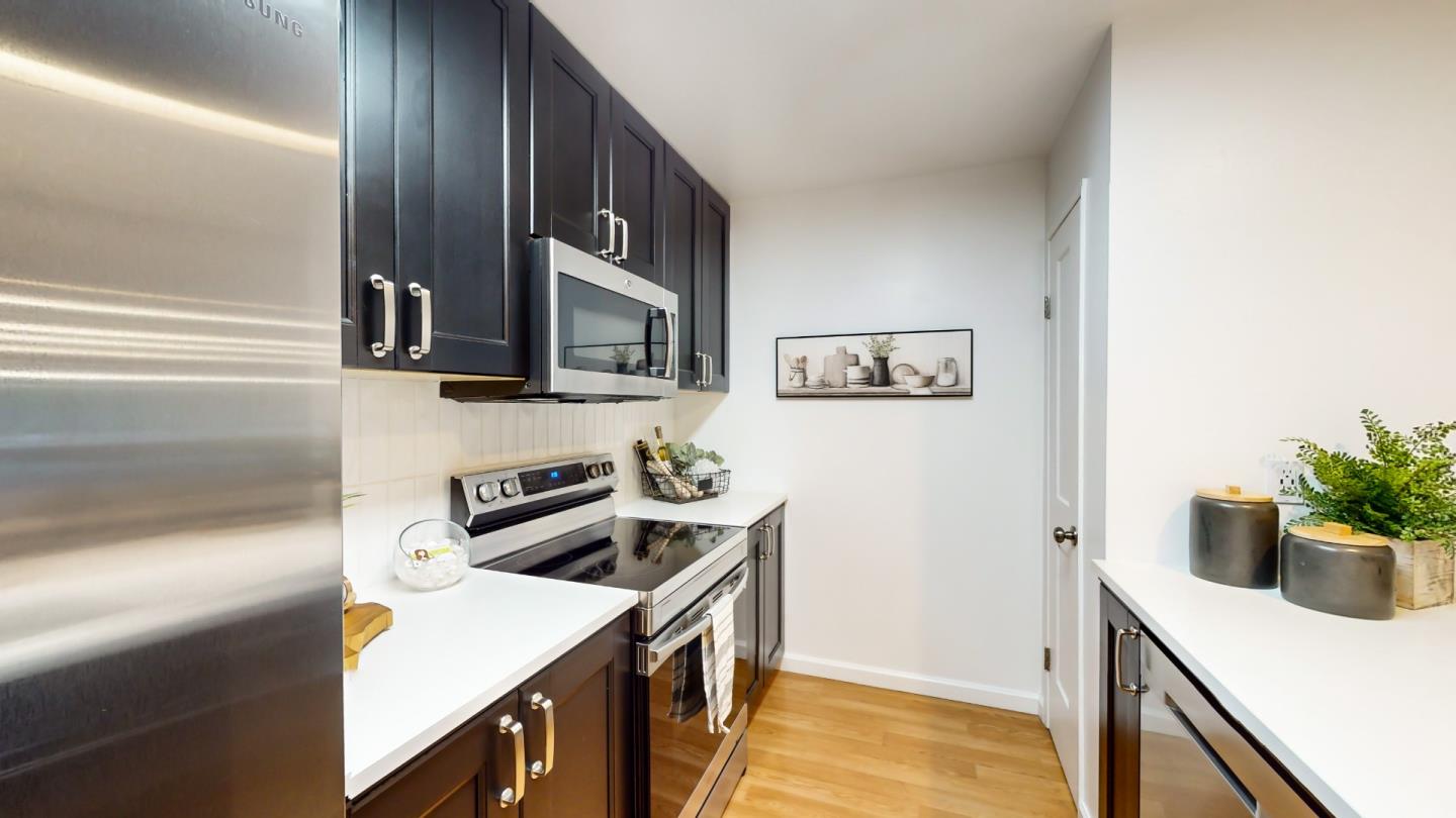 2201 The Alameda, Unit 27 Santa Clara, CA 95050 - Photo 9 of 25 a kitchen that has a microwave and a stove