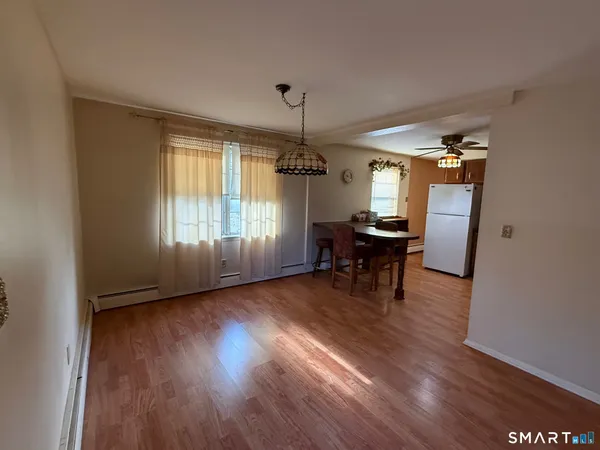 a view of a livingroom with furniture window and wooden floor