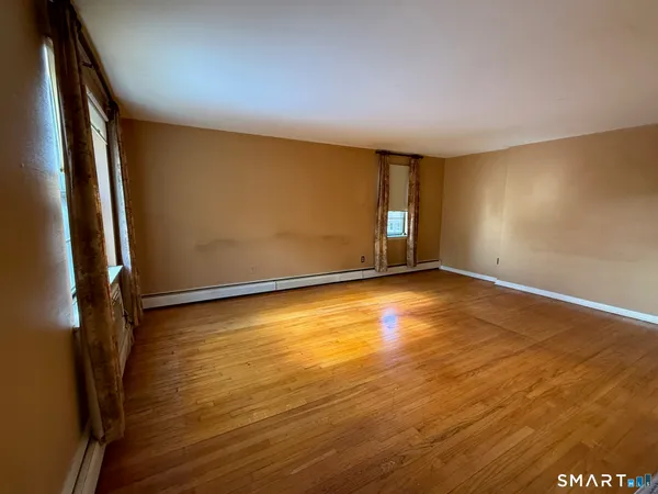 a view of room with window and wooden floor