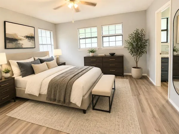 a spacious bedroom with a bed and a large window
