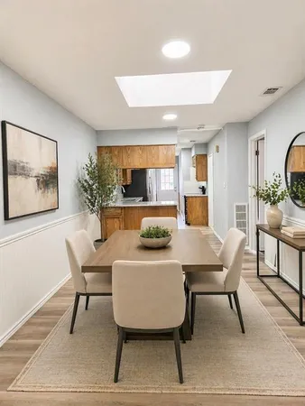 a view of a dining room with furniture and wooden floor