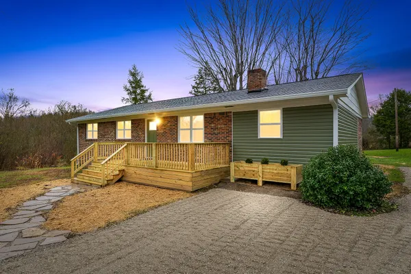 a view of a house with a backyard