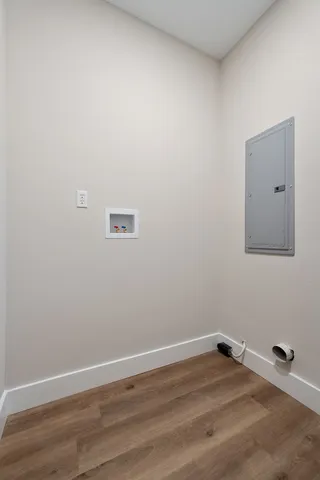 a view of a room with wooden floor and mirror