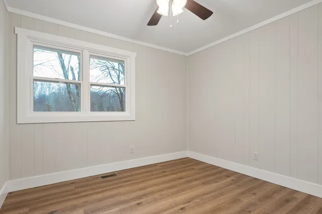 wooden floor in an empty room with a window