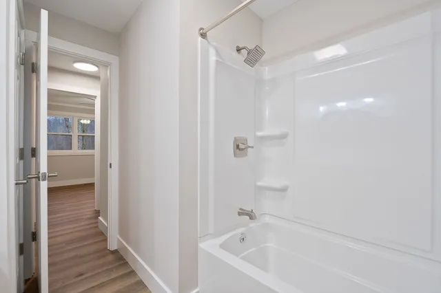 a bathroom with a bathtub and a shower