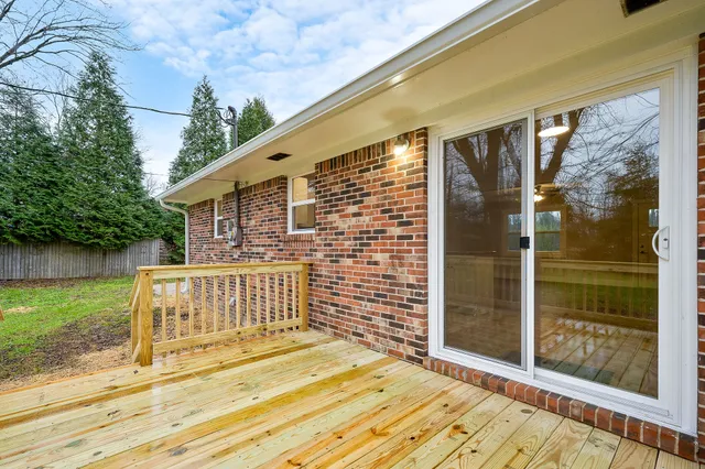 a view of deck with backyard and garden