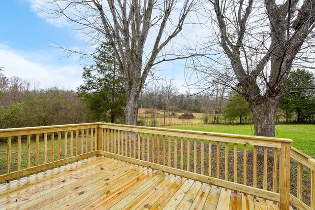 a view of balcony with wooden floor and fence