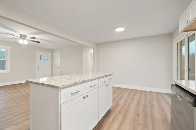a bathroom with a granite countertop sink a vanity and a large mirror