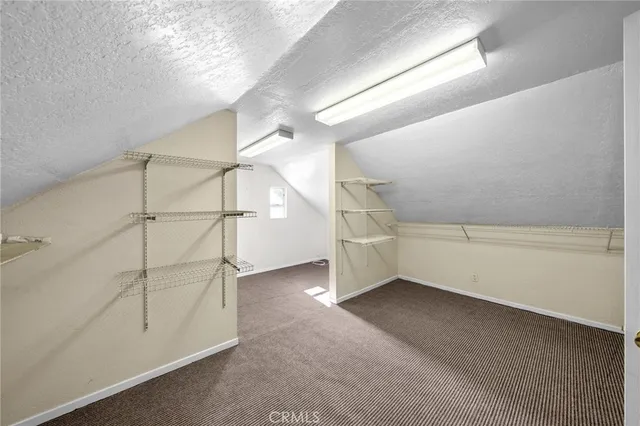 a view of a chandelier fan in big room