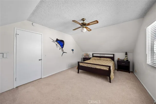 a view of a living room a dining room wooden floor and a large window