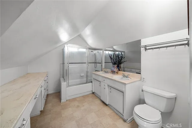 a kitchen with stainless steel appliances granite countertop a stove a sink dishwasher a refrigerator white cabinets and wooden floor