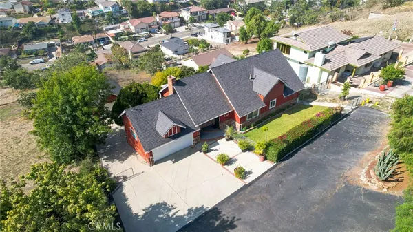 an aerial view of a house with a yard and lake view