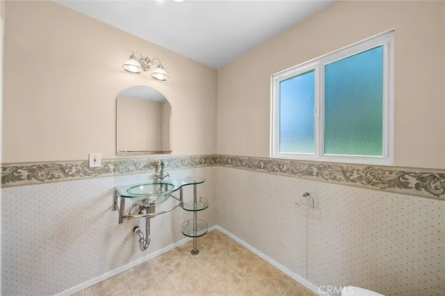 a kitchen with cabinets and wooden floor