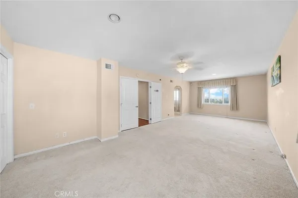 an empty room with wooden floor and outdoor view
