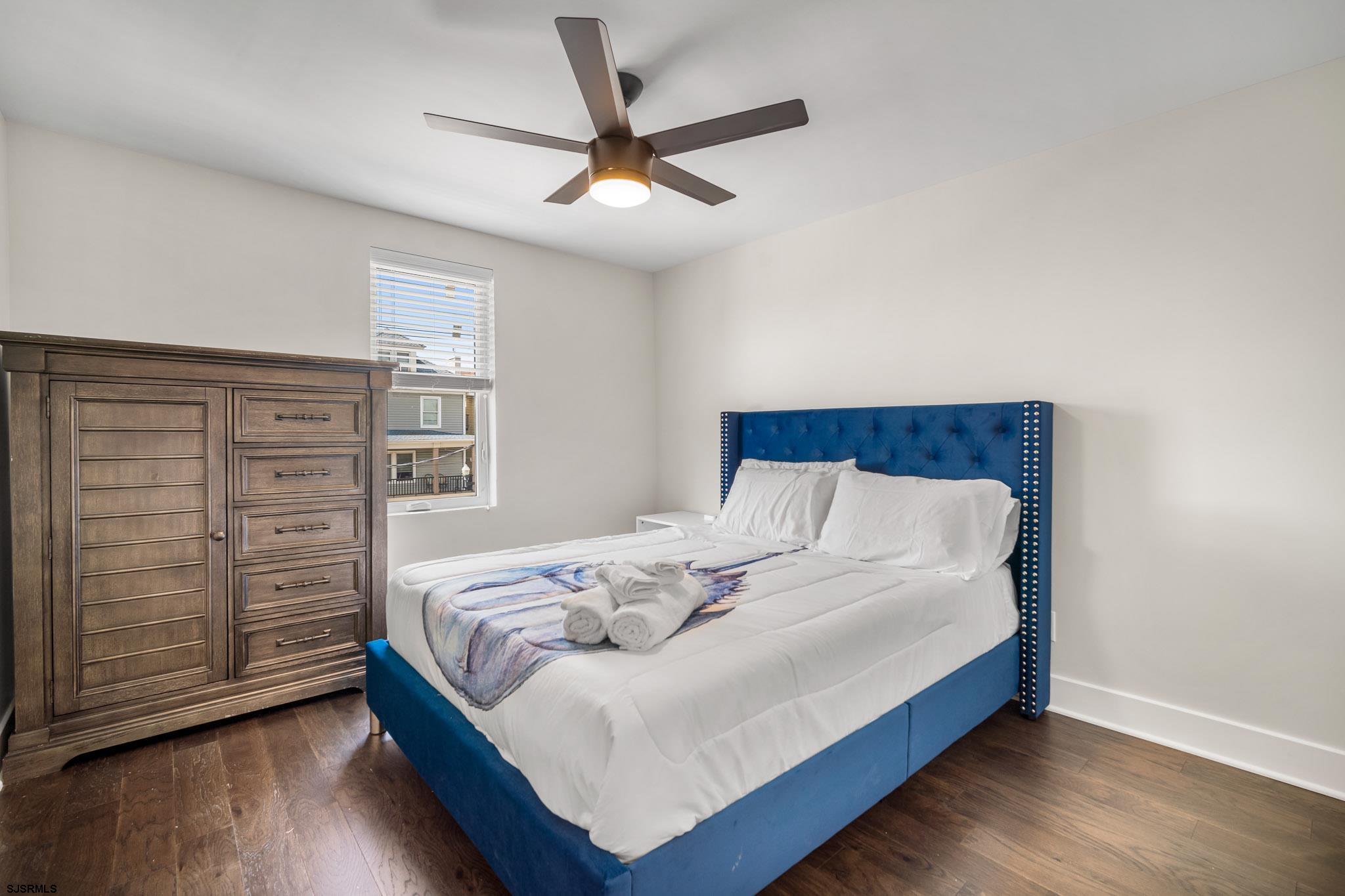 1059 Asbury Avenue, Unit 2 Ocean City, NJ 08226 - Photo 13 of 14 a bedroom with a bed and a ceiling fan