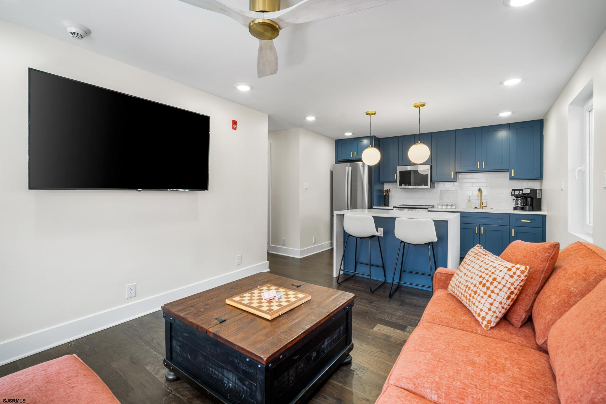 1059 Asbury Avenue, Unit 2 Ocean City, NJ 08226 - Photo 5 of 14 a living room with furniture and a flat screen tv