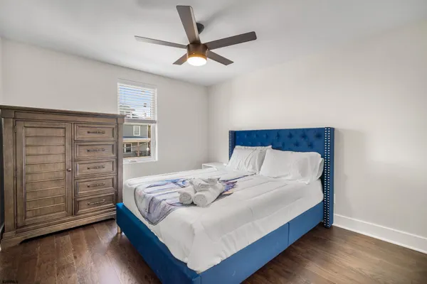 a bedroom with a bed and a ceiling fan