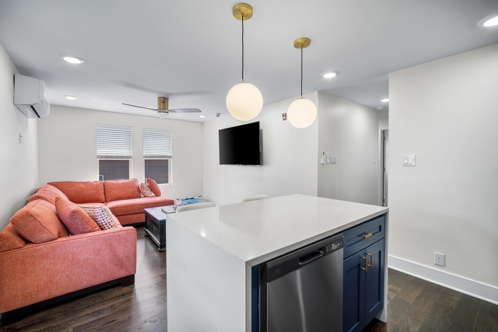 1059 Asbury Avenue, Unit 2 Ocean City, NJ 08226 - Photo 6 of 14 a living room with furniture and a flat screen tv