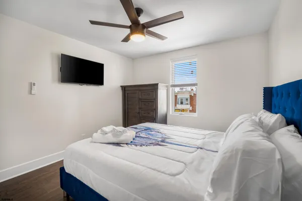 a bedroom with a bed and a flat screen tv