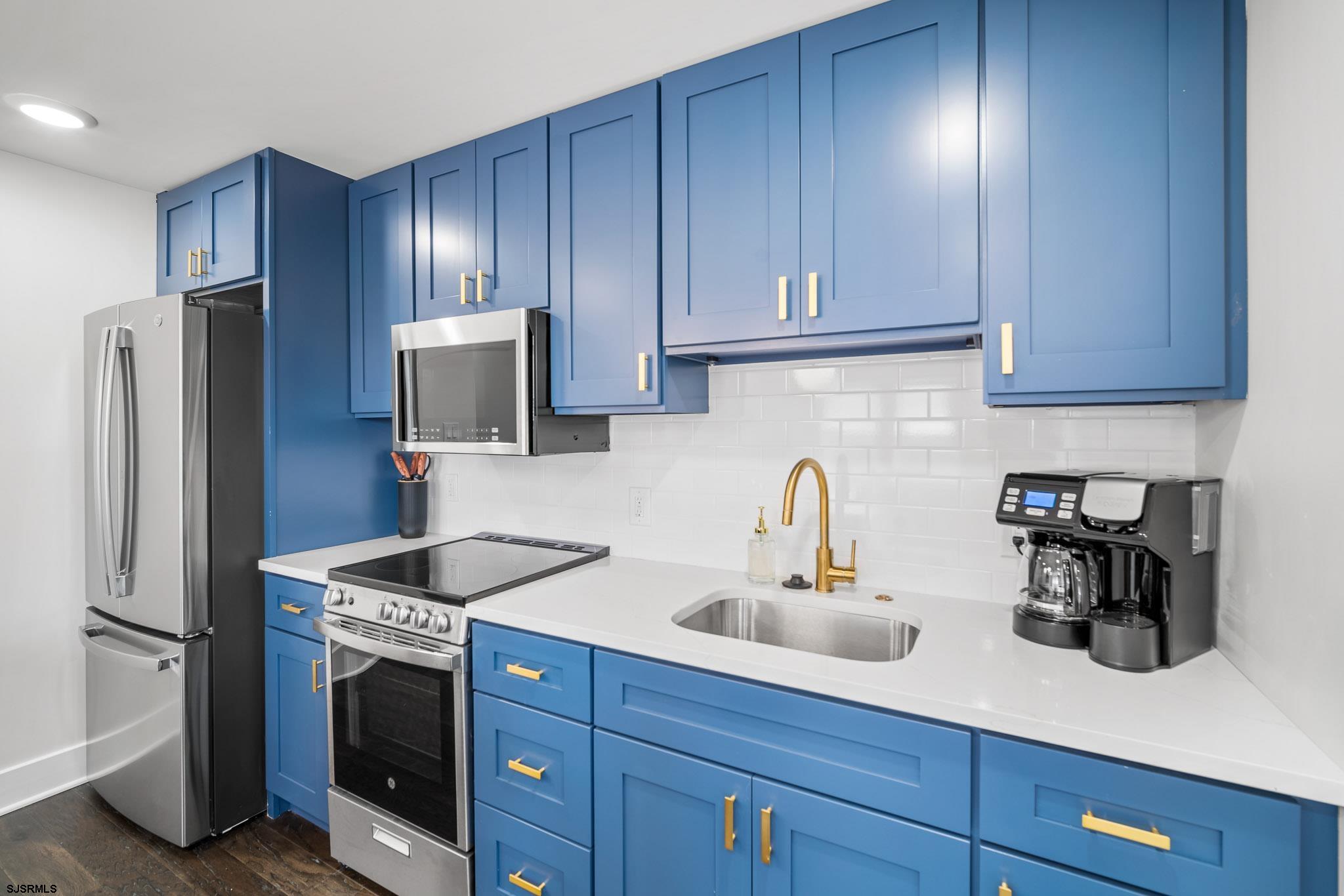 1059 Asbury Avenue, Unit 2 Ocean City, NJ 08226 - Photo 7 of 14 a kitchen with stainless steel appliances granite countertop a refrigerator and a sink