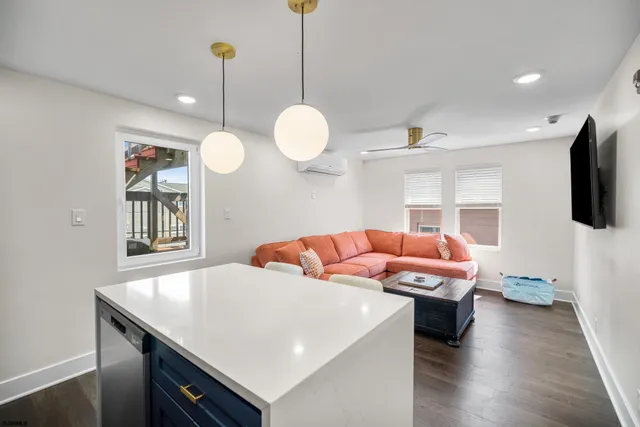 a living room with a couch and chandelier