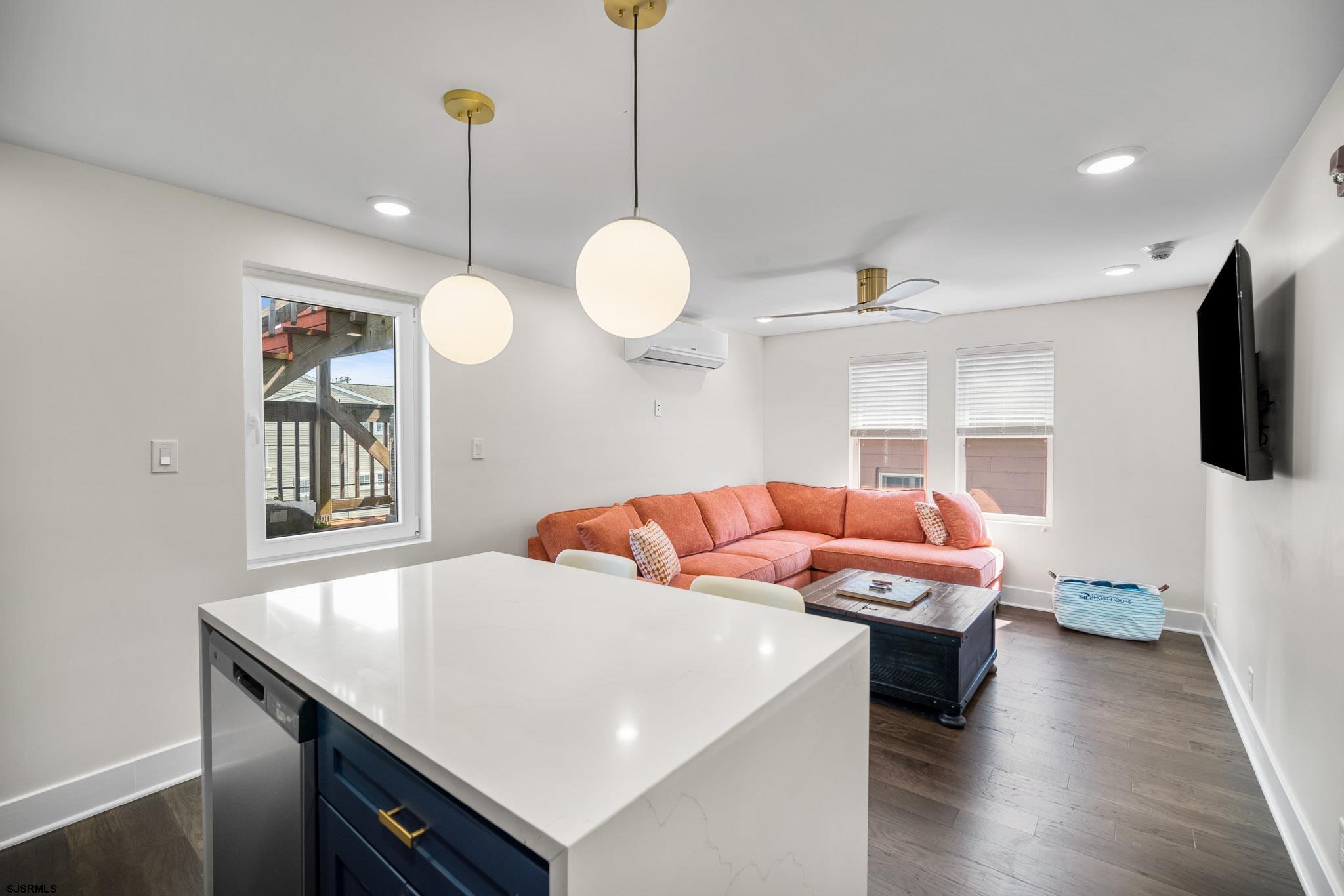 1059 Asbury Avenue, Unit 2 Ocean City, NJ 08226 - Photo 8 of 14 a living room with a couch and chandelier