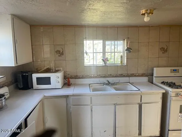 a kitchen that has a sink and a stove