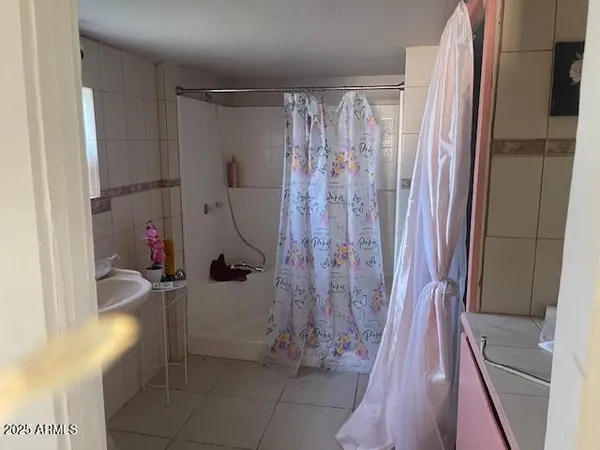 a bathroom with a shower and a sink