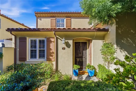front view of a house with potted plants
