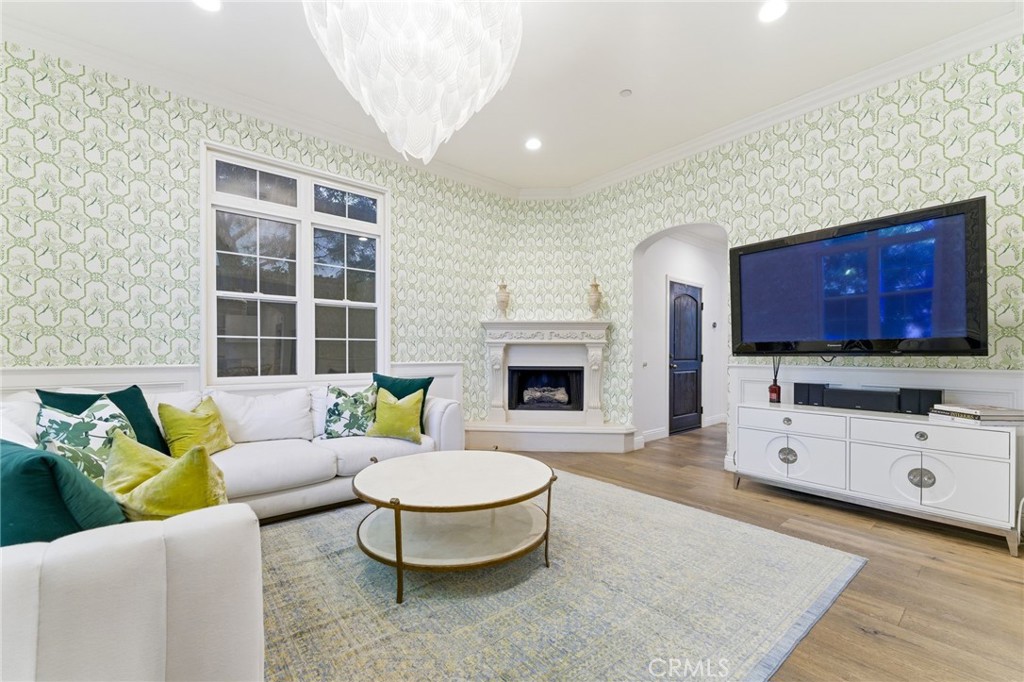 27 Gardenpath Irvine, CA 92603 - Photo 11 of 34 a living room with furniture a fireplace and a flat screen tv