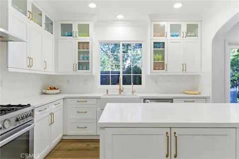 a kitchen with stainless steel appliances white cabinets and a sink
