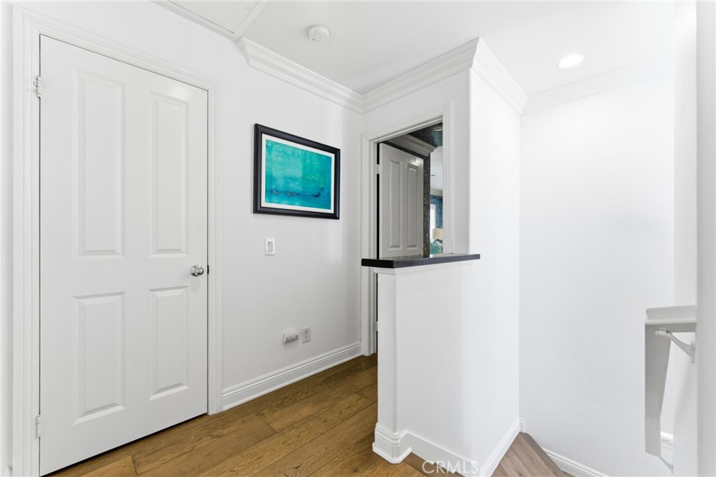 27 Gardenpath Irvine, CA 92603 - Photo 18 of 34 a view of a hallway with wooden floor and closet