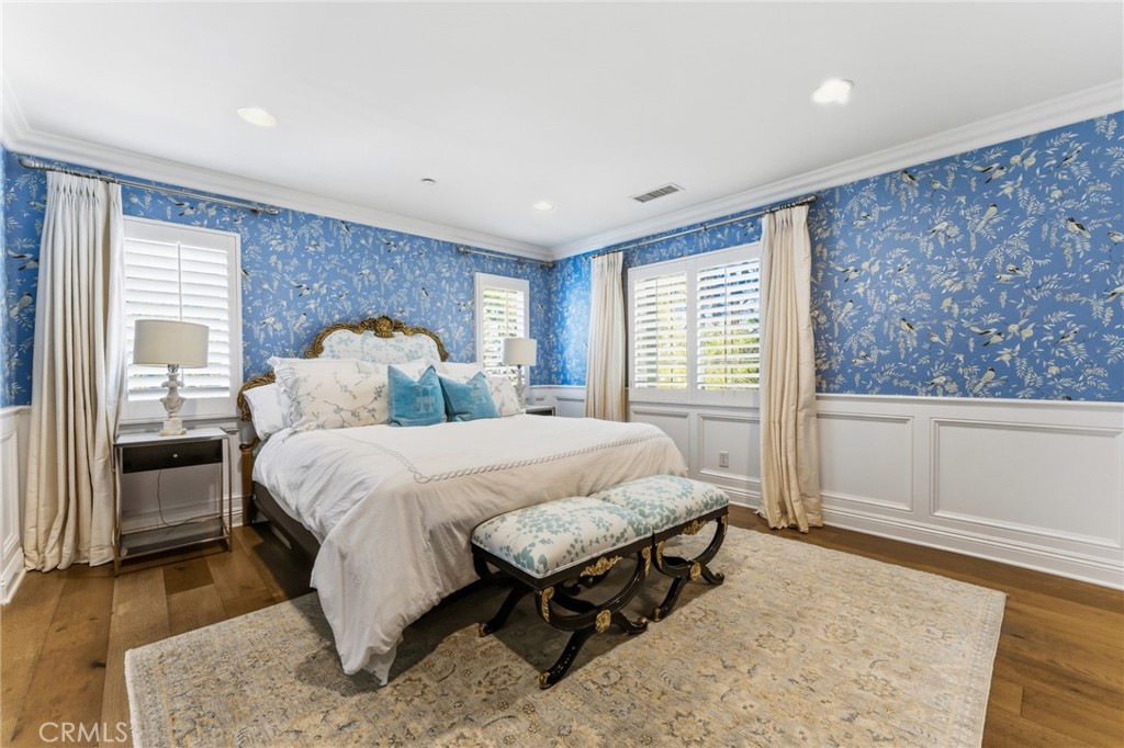 27 Gardenpath Irvine, CA 92603 - Photo 19 of 34 a spacious bedroom with a bed and wooden floor