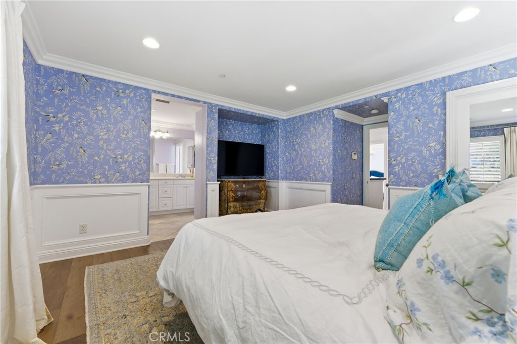 27 Gardenpath Irvine, CA 92603 - Photo 20 of 34 a spacious bedroom with a large bed and a flat screen tv
