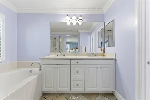 a bathroom with a sink vanity tub and a mirror