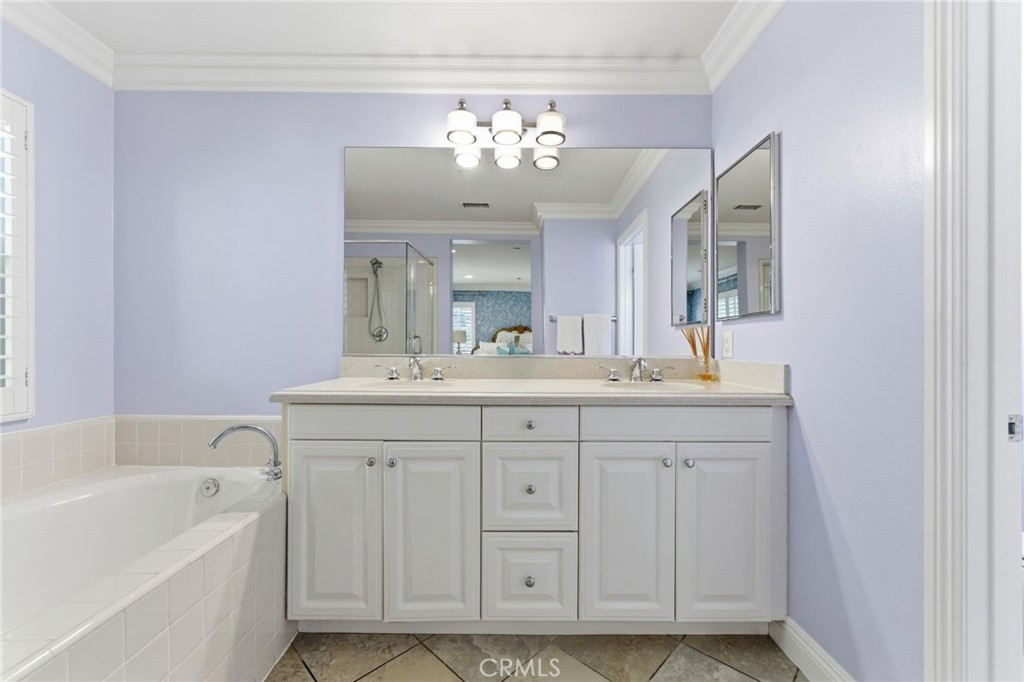 27 Gardenpath Irvine, CA 92603 - Photo 21 of 34 a bathroom with a sink vanity tub and a mirror