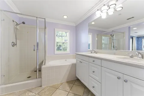 a bathroom with a double vanity sink mirror and shower