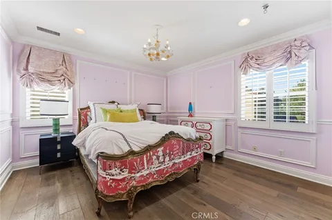 a bedroom with a bed mirror and a window