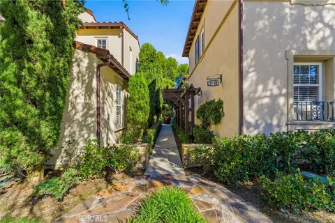 a pathway of a house with a yard