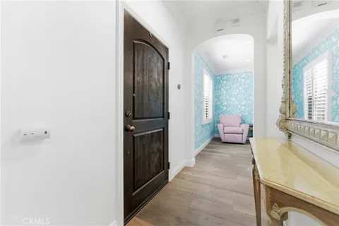 a view of a hallway with a livingroom and a bathroom with sink