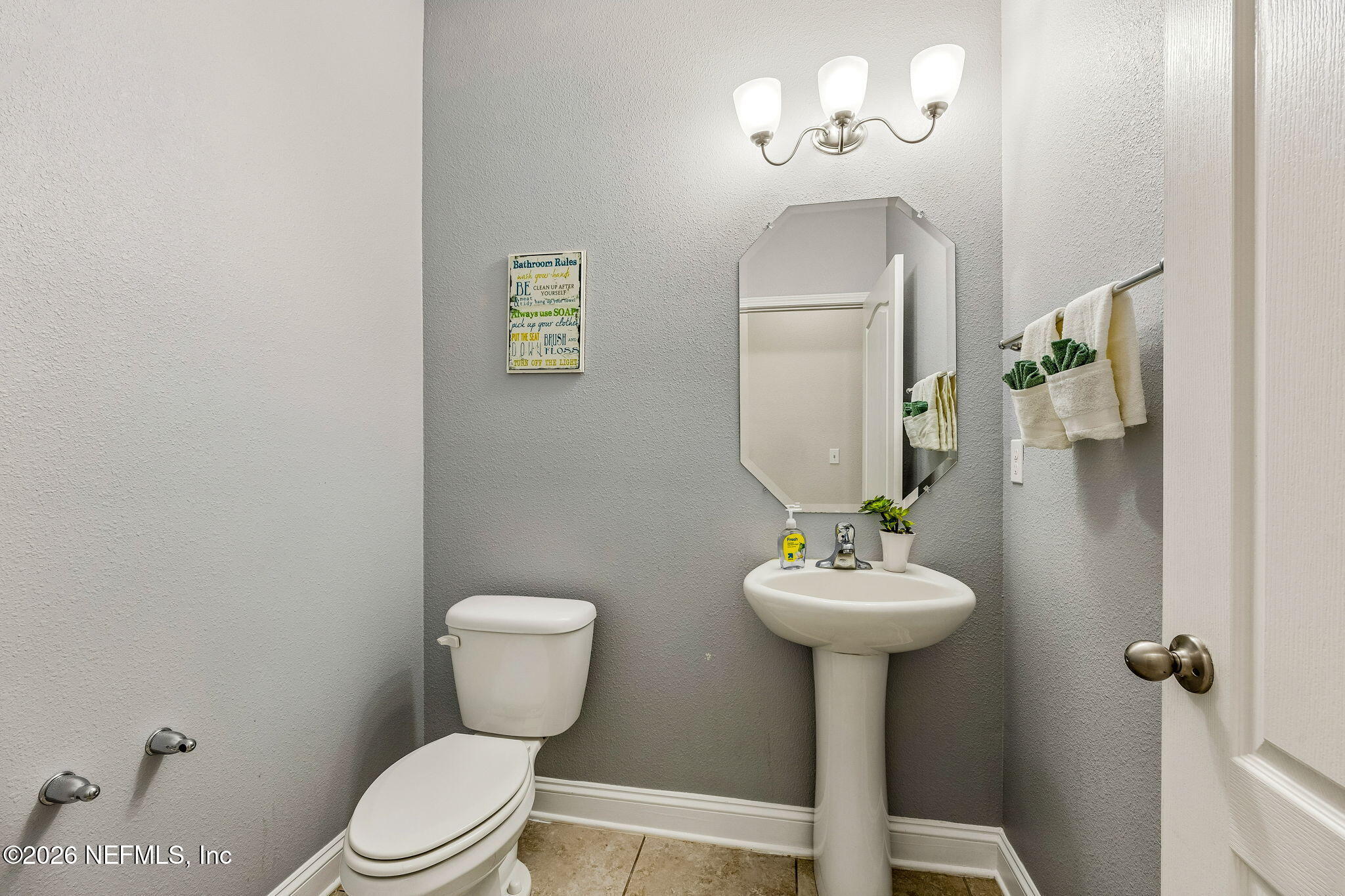 12198 Ridge Crossing Way Jacksonville, FL 32226 - Photo 21 of 67 a bathroom with a toilet sink and mirror